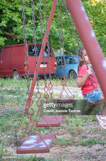 lonely kid swinging - kataraktis village stock pictures, royalty-free photos & images