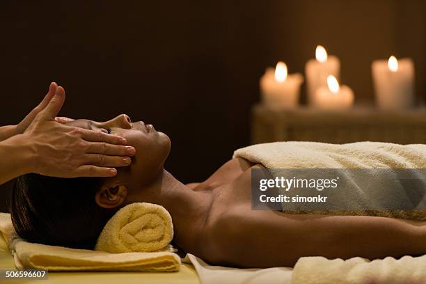 woman having a head massage - massage black woman stock pictures, royalty-free photos & images