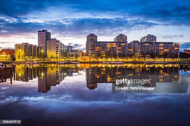 waterfront apartments reflecting in yacht marina harbour at sunset helsinki - helsinki stock pictures, royalty-free photos & images