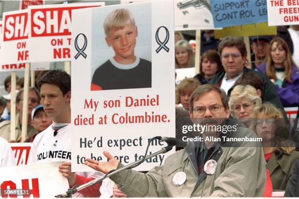 Tom Mauser holding poster of son Daniel, who was killed in shooting rampage at Columbine High School in Littleton, at protest outside NRA convention