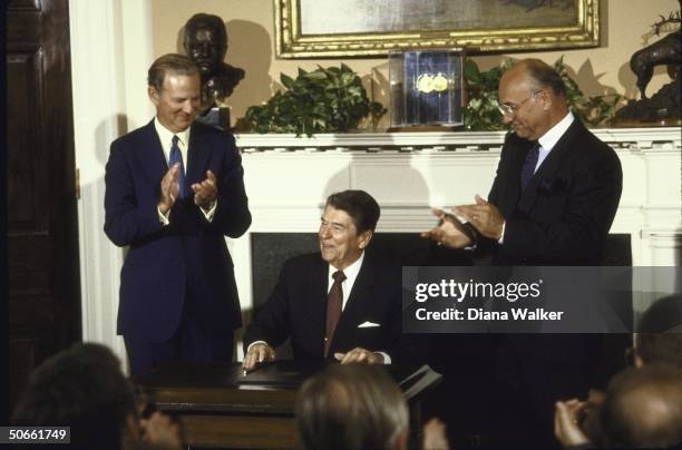 President Ronald W. Reagan signing the Canadian Free Trade Agreement letters of intent.