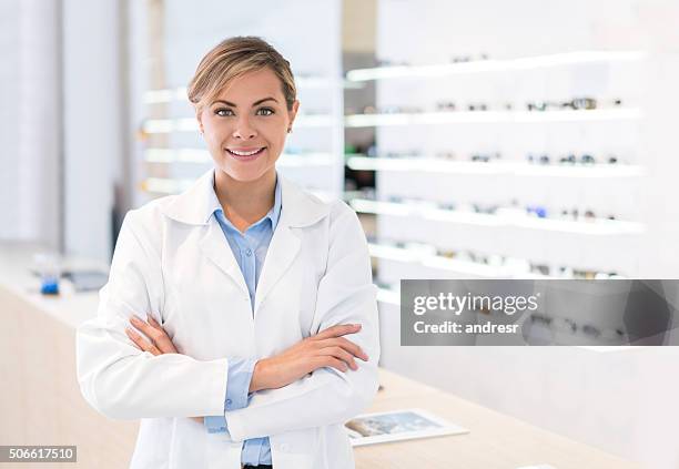 doctor selling glasses at an optician's shop - optical equipment stock pictures, royalty-free photos & images