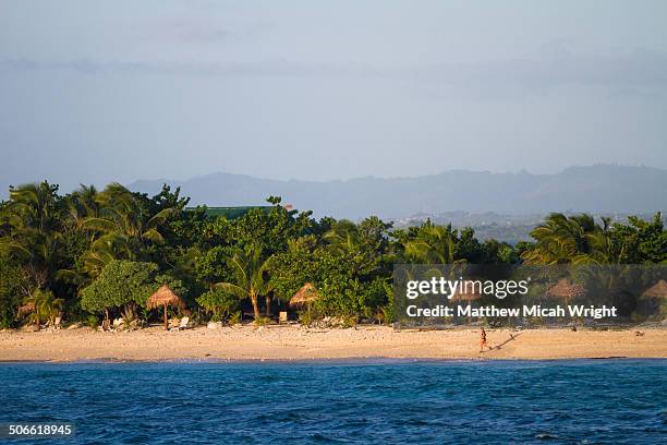 a woman runs around the small island - fiji people stock pictures, royalty-free photos & images