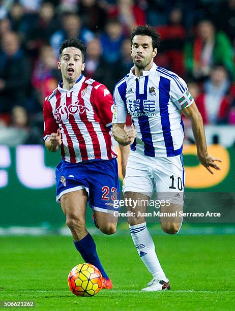 Xabier Prieto of Real Sociedad duels for the ball with Jony Rodriguez of Real Sporting de Gijon during the La Liga match between Real Sporting de...