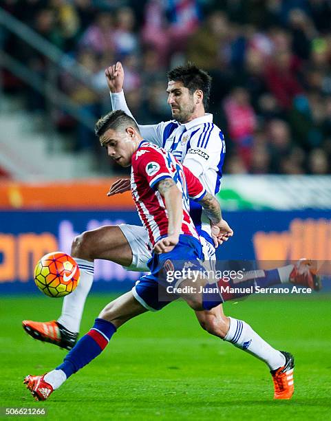 Markel Bergara of Real Sociedad duels for the ball with Arnaldo Sanabria of Real Sporting de Gijon during the La Liga match between Real Sporting de...