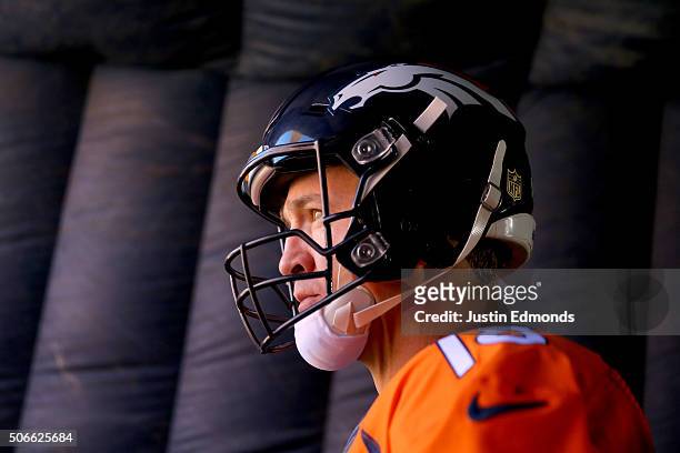 Peyton Manning of the Denver Broncos looks on from the tunnel before the AFC Championship game against the New England Patriots at Sports Authority...