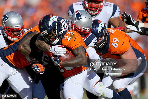 Ronnie Hillman of the Denver Broncos runs with the ball and is tackled by Patrick Chung of the New England Patriots in the first quarter in the AFC...