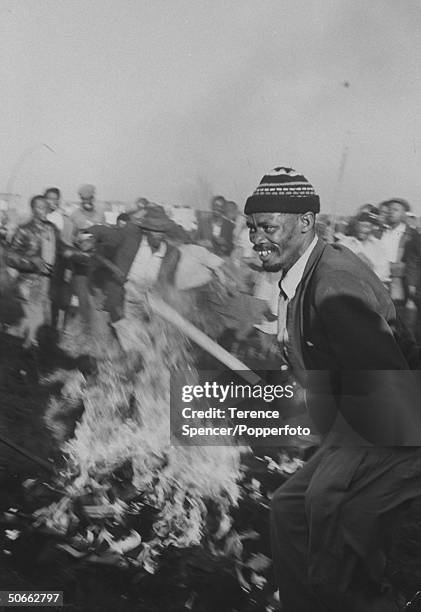 Residents from the township of Sharpeville burn their pass books during a demonstration against government pass laws as part of a day of protest at...