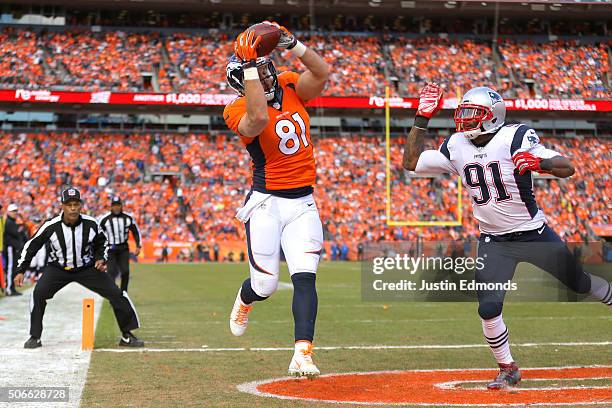 Owen Daniels of the Denver Broncos catches a 12-yard touchdown pass in the second quarter against Jamie Collins of the New England Patriots in the...