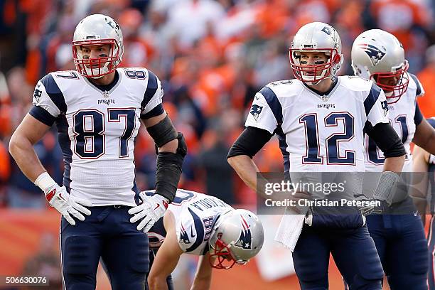 Rob Gronkowski and Tom Brady of the New England Patriots look on in the first half against the Denver Broncos in the AFC Championship game at Sports...