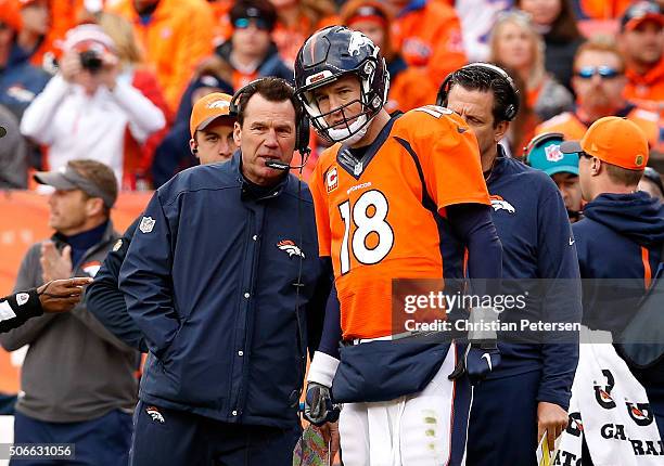 Head coach Gary Kubiak of the Denver Broncos speaks to Peyton Manning in the first half against the New England Patriots in the AFC Championship game...