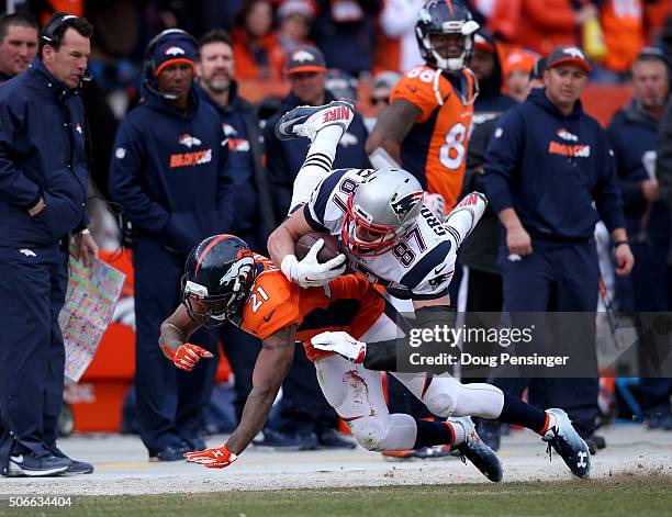 Aqib Talib of the Denver Broncos tackles Rob Gronkowski of the New England Patriots after a first down in the third quarter in the AFC Championship...