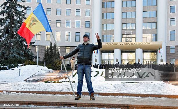 Policeman stand guard in front of the government building as opponent Moldovans stage anti-government protests, demanding resignation of the...