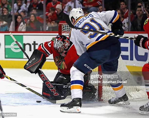 Corey Crawford of the Chicago Blackhawks stops a shot by Vladimir Tarasenko of the St. Louis Blues at the United Center on January 24, 2016 in...