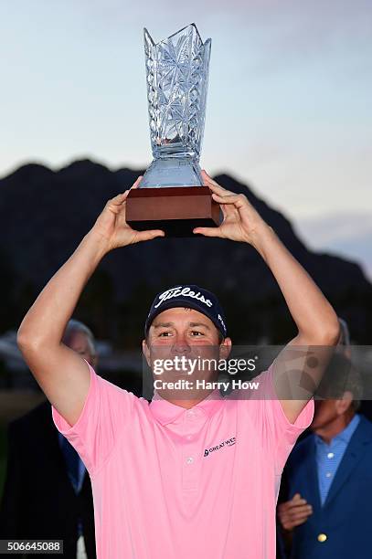 Jason Dufner poses with the trophy after winning the CareerBuilder Challenge In Partnership With The Clinton Foundation at the TPC Stadium course at...