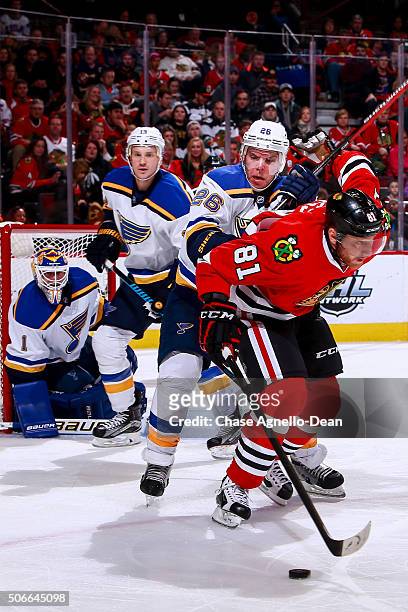 Paul Stastny of the St. Louis Blues gets physical with Marian Hossa of the Chicago Blackhawks in the second period of the NHL game at the United...