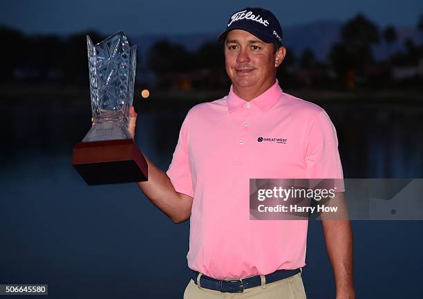 Jason Dufner poses with the trophy after winning the CareerBuilder Challenge In Partnership With The Clinton Foundation at the TPC Stadium course at...