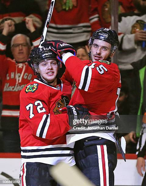 Artemi Panarin of the Chicago Blackhawks gets a hug from Artem Anisimov after scoring a second period goal against the St. Louis Blues at the United...