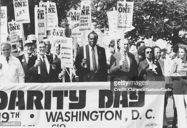 Protesters and members of the AFL CIO marching and holding signs during the National Association for the Advancement of Colored People We Are One...