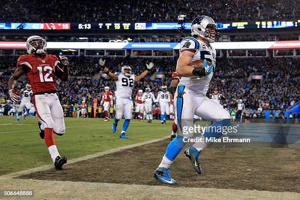Luke Kuechly of the Carolina Panthers scores a touchdown after intercepting a pass in the fourth quarter against the Arizona Cardinals during the NFC...