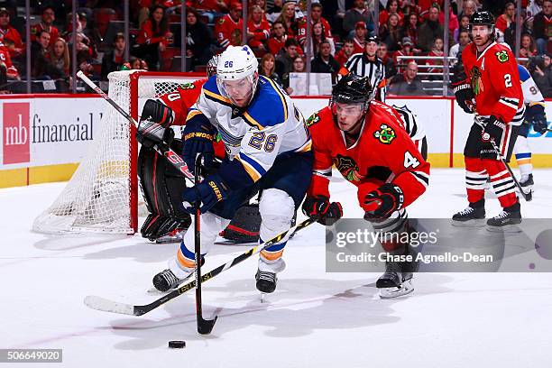 Paul Stastny of the St. Louis Blues and Niklas Hjalmarsson of the Chicago Blackhawks chase the puck in the third period of the NHL game at the United...