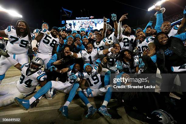 Cam Newton of the Carolina Panthers celebrates with teammates on the sideline in the fourth quarter against the Arizona Cardinals during the NFC...