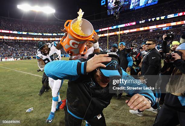Head coach Ron Rivera of the Carolina Panthers is doused with Gatorade by Charles Johnson and Cam Newton after the Carolina Panthers defeat the...