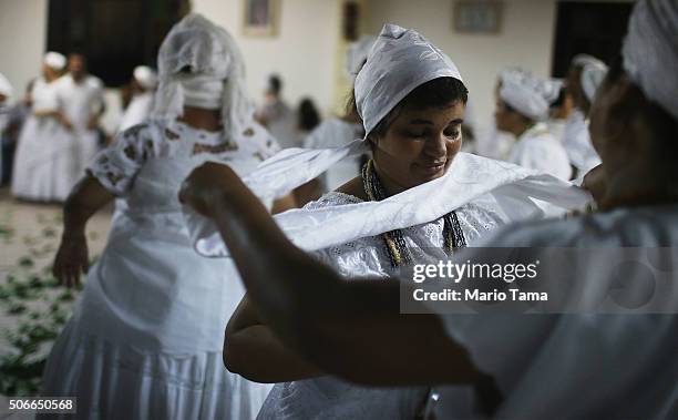Worshippers gather during a Candomble ceremony on January 24, 2016 in Itaborai, Brazil. Candomble is an Afro-Brazilian religion whose practitioners...
