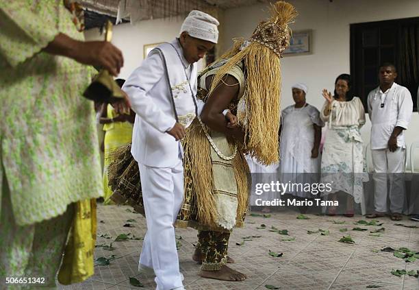 Worshippers gather during a Candomble ceremony on January 24, 2016 in Itaborai, Brazil. Candomble is an Afro-Brazilian religion whose practitioners...