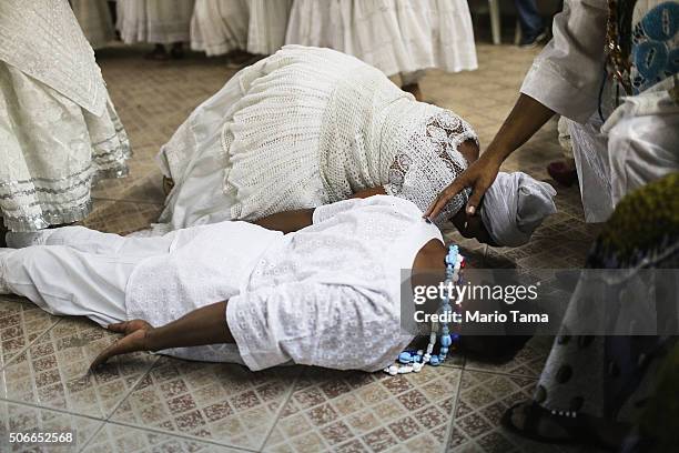 Worshippers lie on the floor during a Candomble ceremony on January 24, 2016 in Itaborai, Brazil. Candomble is an Afro-Brazilian religion whose...