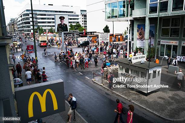 Tourists crowd around Checkpoint Charlie, the most well known crossing point between East and West Berlin during the Cold War. At Midnight on...