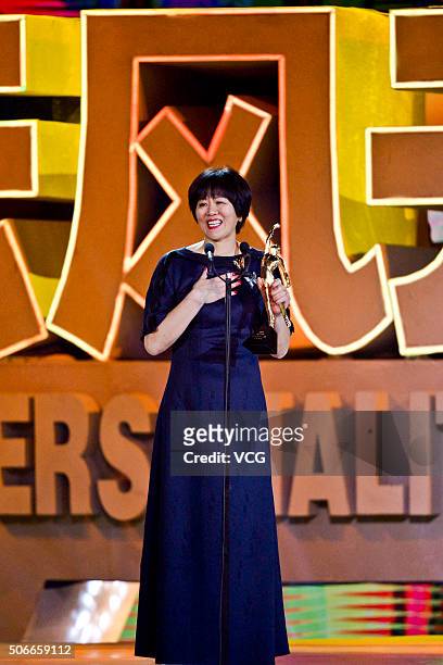 Lang Ping, former head coach of Chinese women's national volleyball team, poses with the trophy during the Sports Personality of the Year 2015 on...