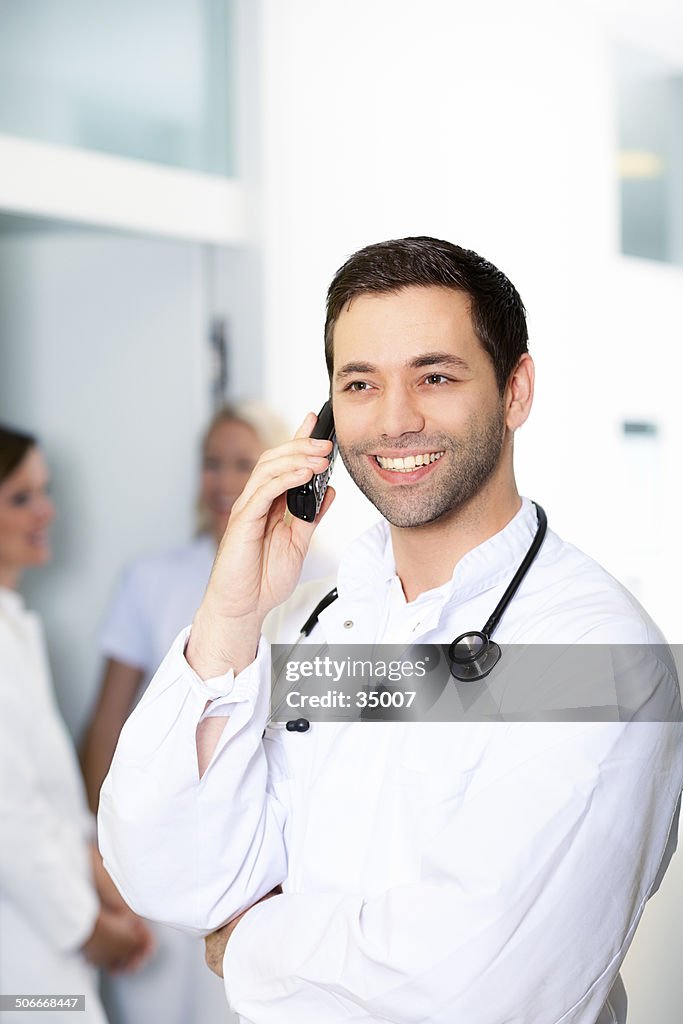 Smiling doctor on the phone