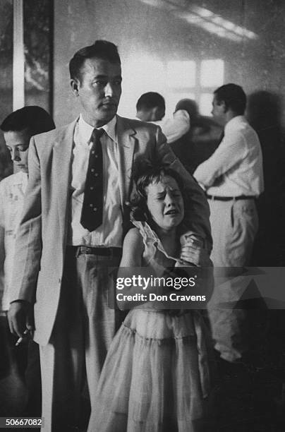 Fireman Clyde Cook standing with his son Clyde Jr. And consoling weeping daughter Caroline in court after being found guilty of contempt for...