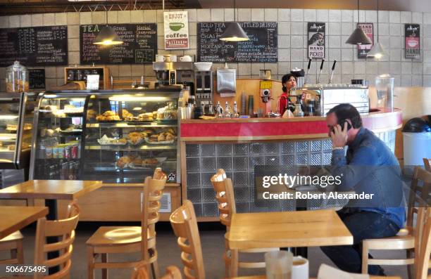 Santa Fe, New Mexico, resident enjoys a newspaper and cup of coffee at Downtown Subscription coffee bar and newstand, a popular gathering place in...