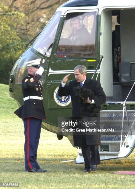 Guard saluting President George W. Bush after return via Marine One helicopter to White House fr. His Crawford, Texas ranch.