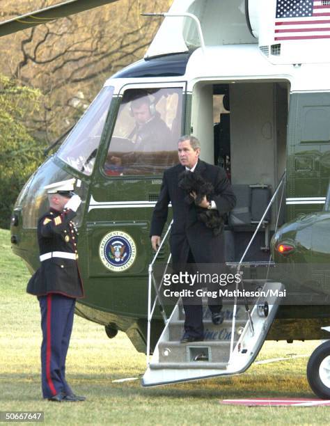 Marine guard saluting President George W. Bush as he alights fr. Marine One helicopter returning fr. His Crawford, Texas ranch.
