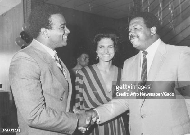 Politician and Maryland congressional representative Elijah Cummings shaking hands, 1984.