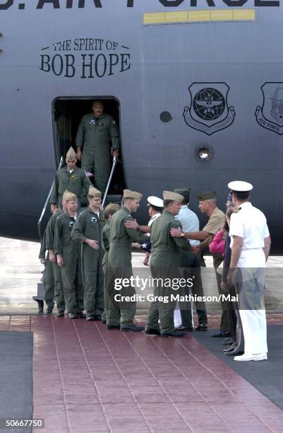 Crew members from U.S. Navy EP-3 Aries II aircraft involved in the April 1 accident with a Chinese F-8 aircraft being welcomed by senior military...