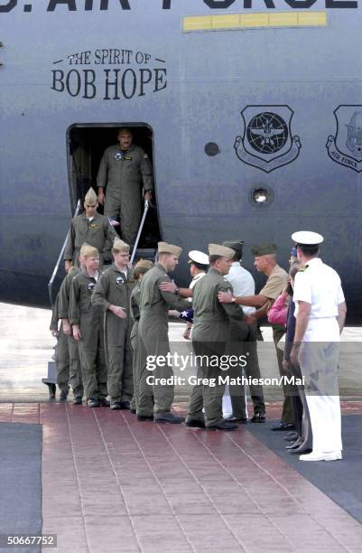 Crew members from the U.S. Navy EP-3 Aries II aircraft involved in the April 1 accident with a Chinese F-8 aircraft being welcomed by senior military...