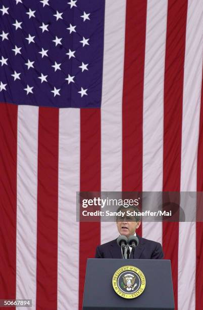 President George W. Bush giving a speech after laying a wreath at the Tomb of the Unknowns at Arlington National Cemetery.