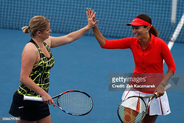 Kim Clijsters of Belgium and Iva Majoli of Croatia compete in their match against Lindsay Davenport of the United States and Martina Navratilova of...