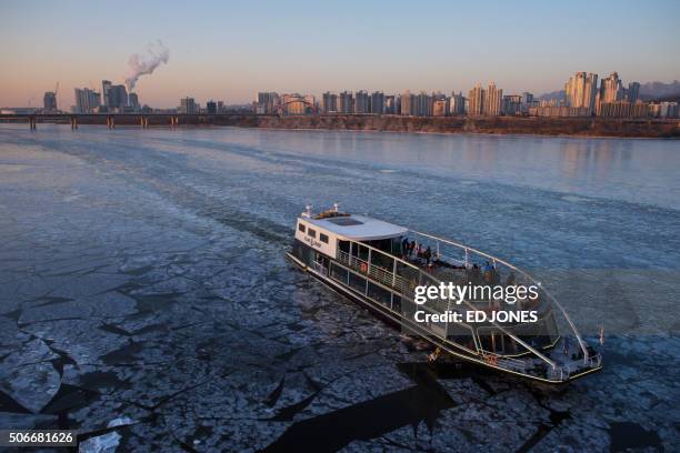 Cruise boat makes it way through ice on the Han river in Seoul on January 25, 2015. Temperatures in the South Korean capital fell to minus 18 degrees...