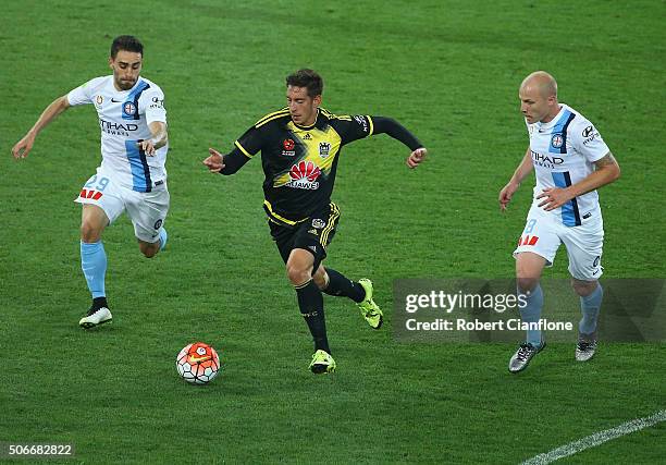 Alex Rodriguez of the Phoenix is chased by Anthony Caceres and Aaron Mooy of Melbourne City during the round 16 A-League match between Melbourne City...