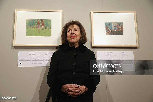 Holocaust survivor Nelly Toll stands next to two gouache pieces she painted as a child while living in the Lviv ghetto during World War II at the...