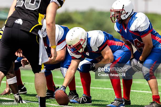 sports: football teams prepare for a play.  line of scrimmage. - high school stock pictures, royalty-free photos & images