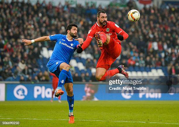 Hugo Almeida of Hannover is challenged by Aytac Sulu of Darmstadt during the Bundesliga match between Hannover 96 and SV Darmstadt 98 at HDI-Arena on...