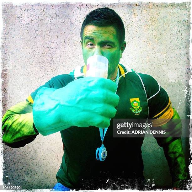 In a picture taken with a mobile phone a South African rugby Fan poses for a photograph has he arrives for the quarter-final match of the 2015 Rugby...