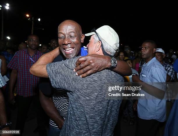 Keith Christopher Rowley , Prime Minister of Trinidad & Tobago, hugs an admirer at the semi-finals of Panorama in the Queen's Park Savannah during...