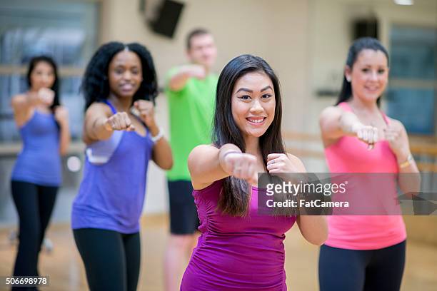 throwing a punch at the gym - kickboxing training stock pictures, royalty-free photos & images